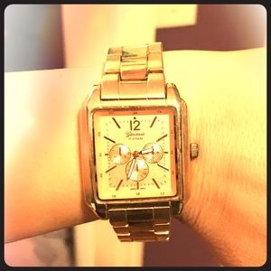 Rose gold toned watch.